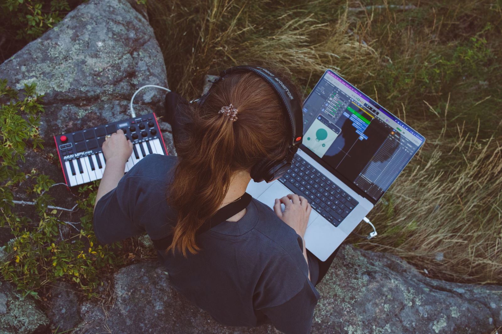 Girl producing music out in the nature.